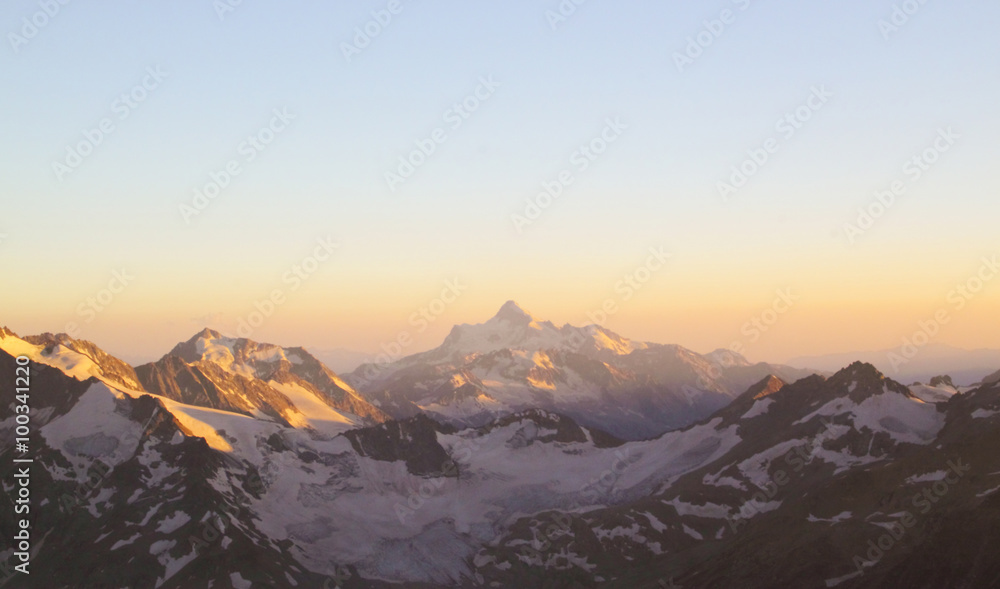 Panorama of mountain peaks in the setting sun, the majesty and b