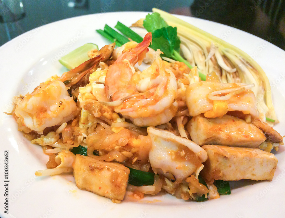 Stir-fried Rice Noodles (Pad Thai) with Shrimp and Squid in White Plate Stir-fried Rice Noodles (Pad Thai) with Shrimp and Squid in White Plate