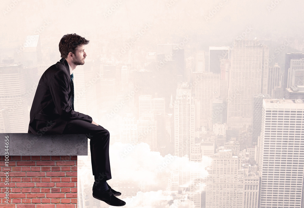 Office worker sitting on rooftop in city Office worker sitting on rooftop in city