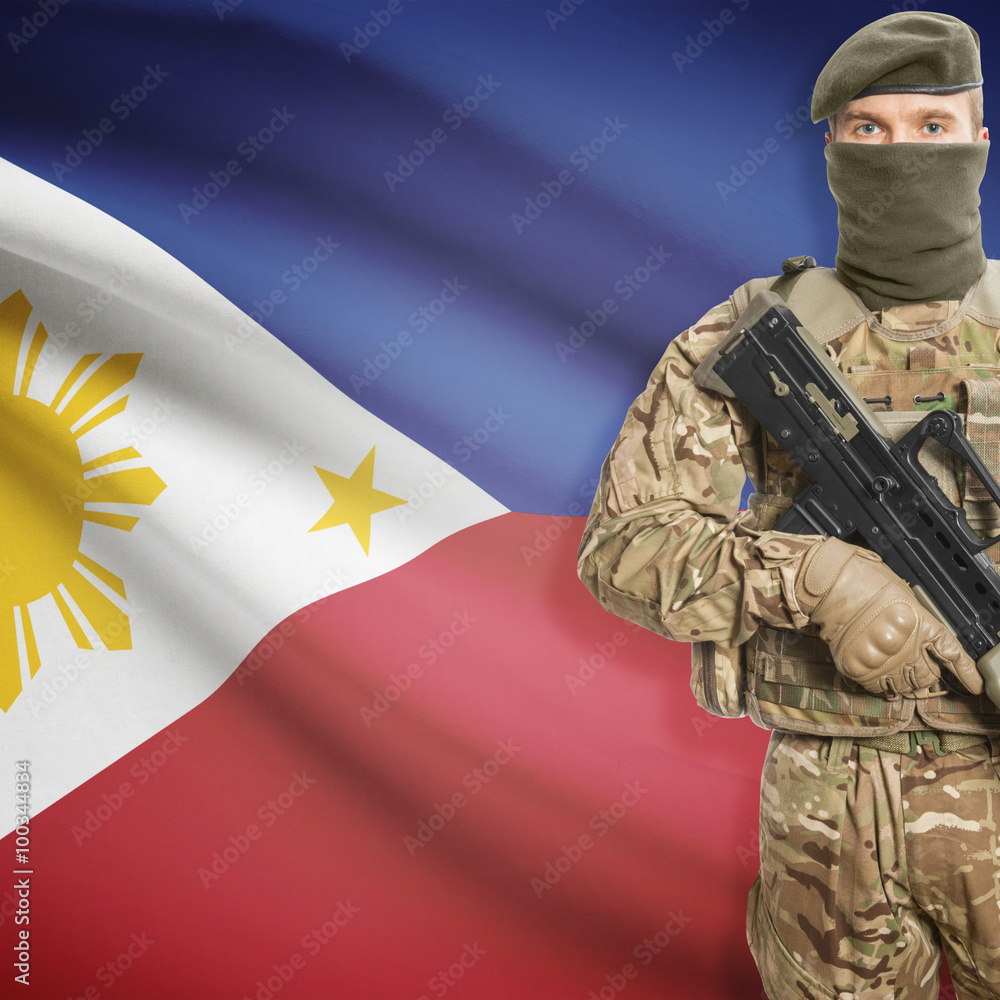 Fototapeta premium Soldier with machine gun and flag on background - Philippines