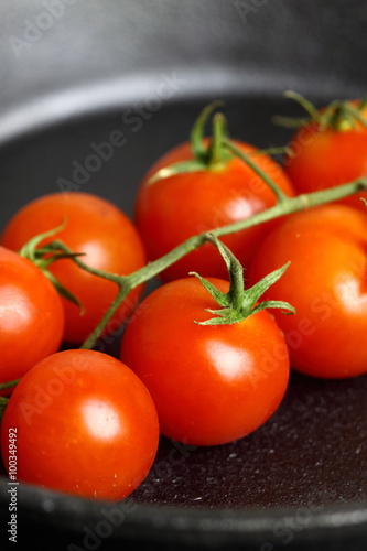 Frying tomatoes cast iron pan / Frying cherry tomatoes in a cast iron frying pan
