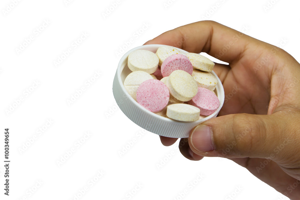 Vitamin C tablets on hand isolated on white Vitamin C tablets on hand isolated on white