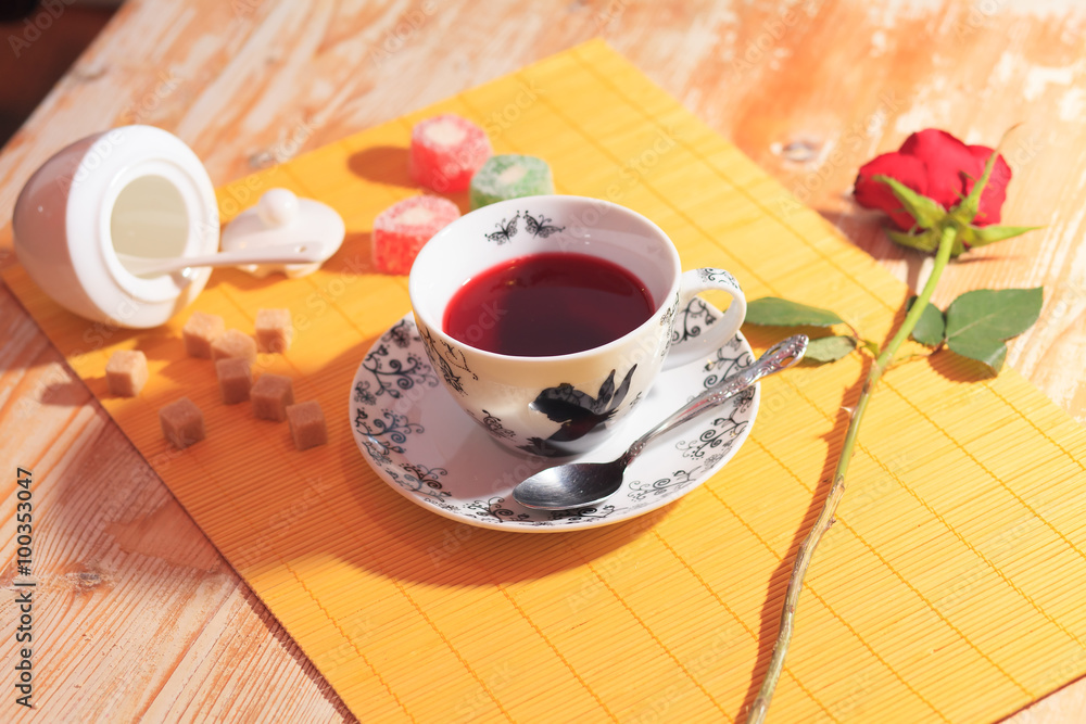 Obraz premium cup of tea, sweets and red rose