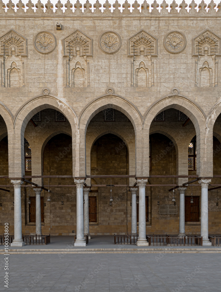 Arched surrounding the courtyard of a historic mosque, Cairo, Eg