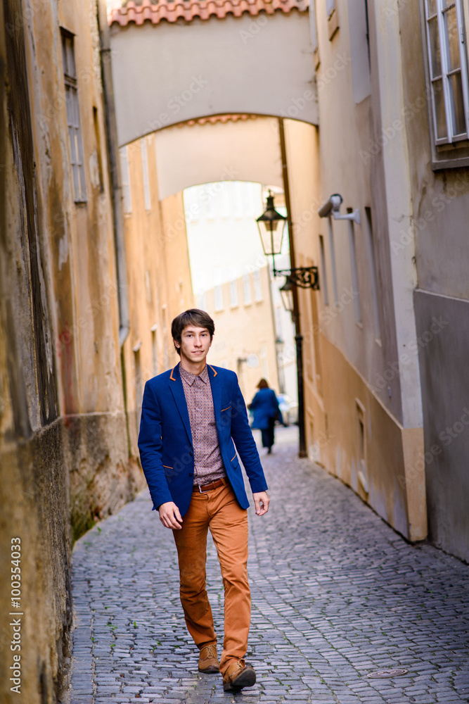man in beige pants and a blue blazer