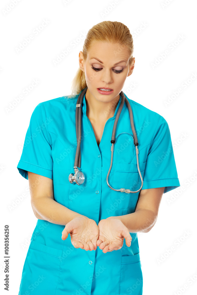 Female doctor or nurse holding something on open palms Female doctor or nurse holding something on open palms
