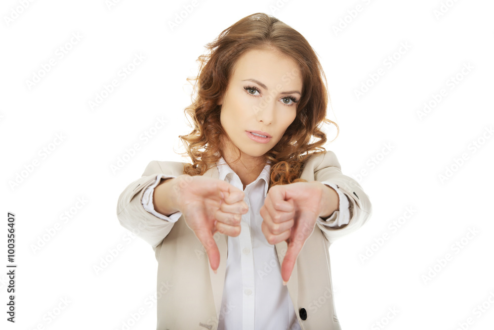 Businesswoman with thumbs down gesture. Businesswoman with thumbs down gesture.