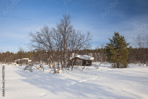 Wooden Building On Snow Covered Field
