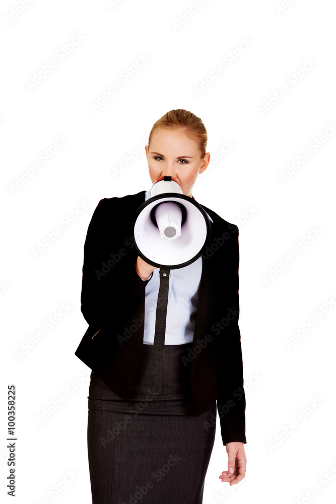 Young business woman screaming through megaphone Young business woman screaming through megaphone