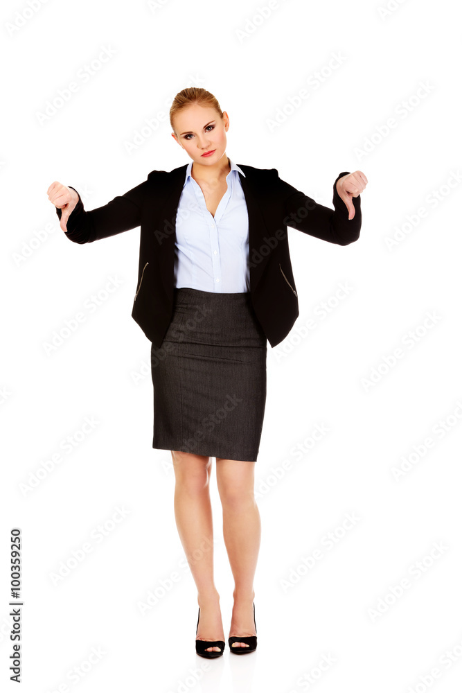 Unhappy businesswoman with thumbs down gesture Unhappy businesswoman with thumbs down gesture