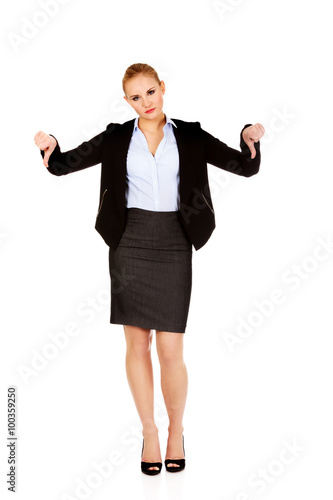 Unhappy businesswoman with thumbs down gesture