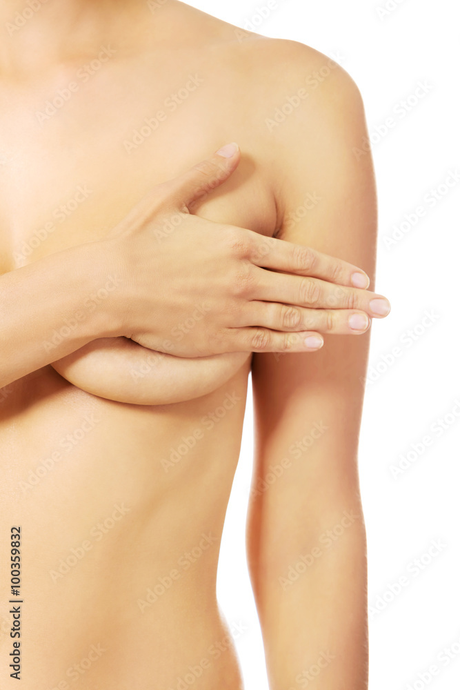 Topless woman covering her breast with hand