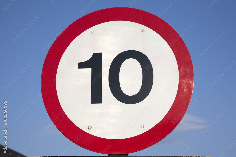 Ten Speed Limit Sign on Blue Sky Background Ten Speed Limit Sign on Blue Sky Background