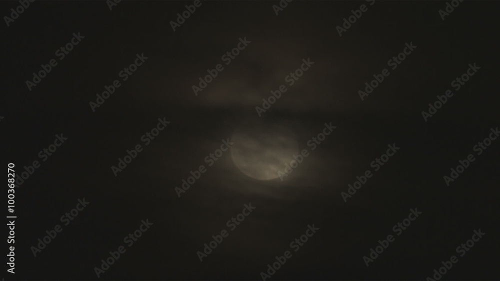 Shot of a full moon with clouds covering the top half Shot of a full moon with clouds covering the top half