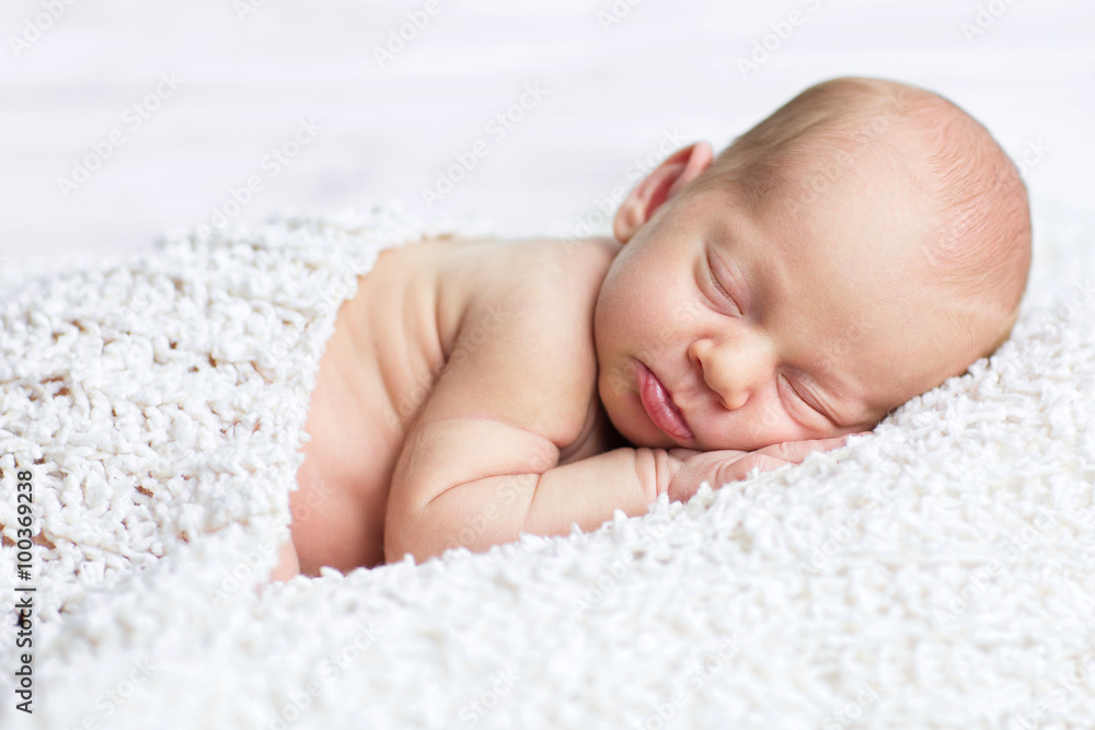 adorable newborn boy sleeps on the white blanket with background adorable newborn boy sleeps on the white blanket with background
