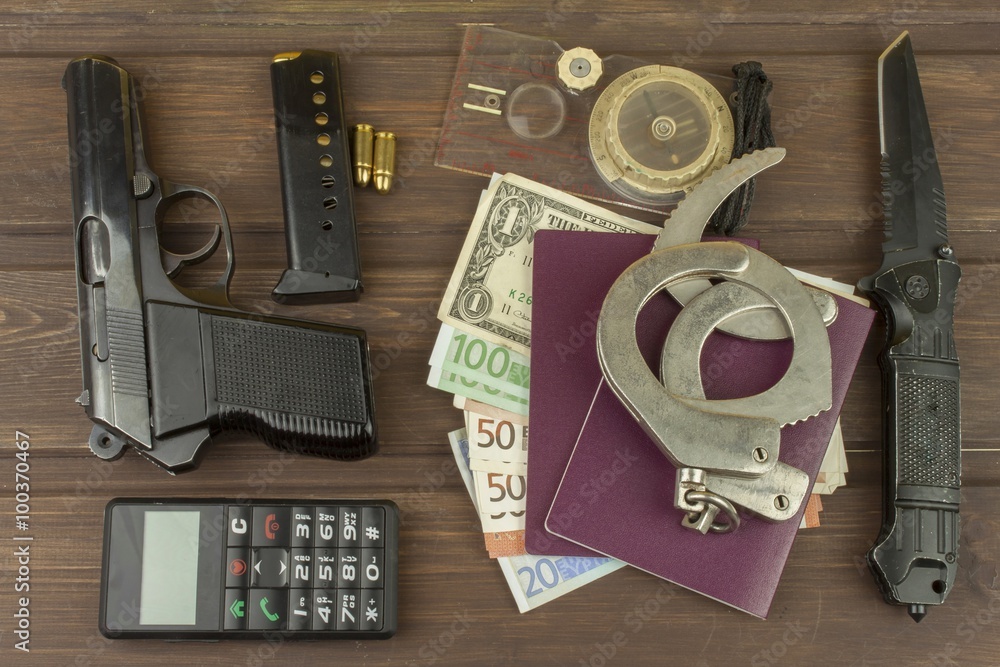 Obraz premium Traffickers international crime. Illegal crossing of the state border. Smuggling for money. Illegal immigrants. Paying smugglers for crossing the border. Real money and fake documents on the table. 