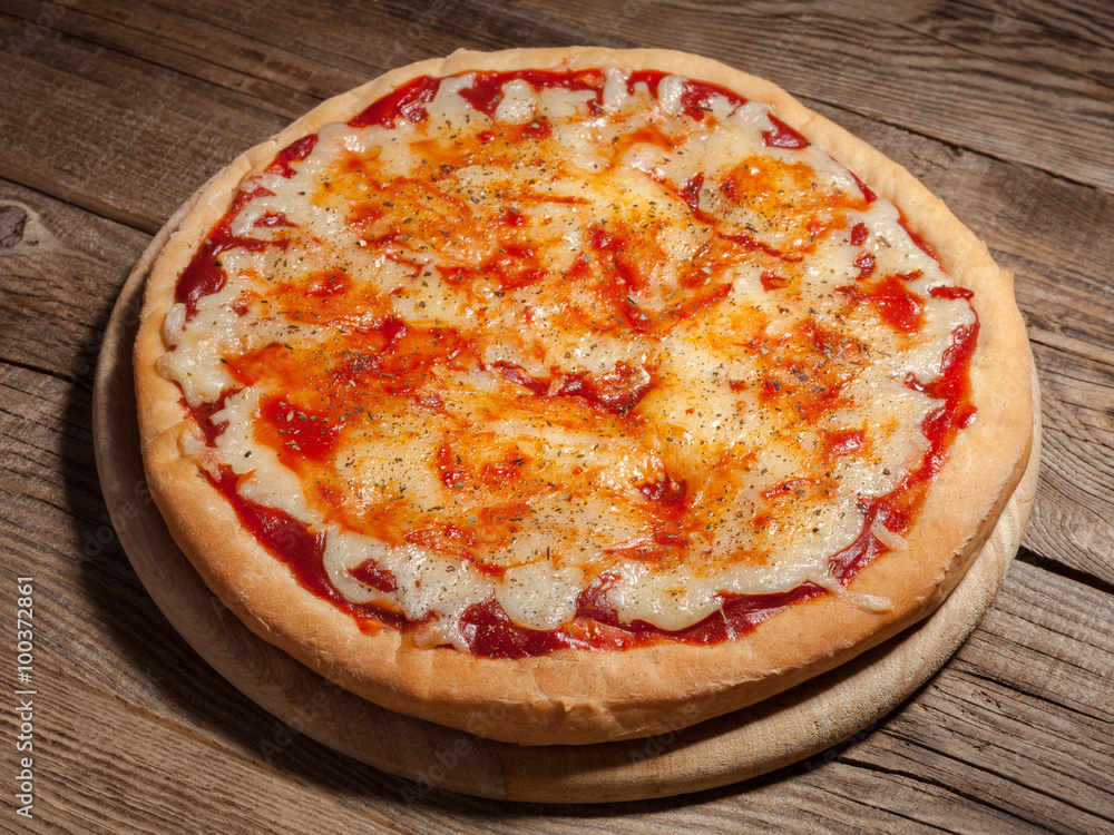 Delicious italian pizza served on wooden board Delicious italian pizza served on wooden board