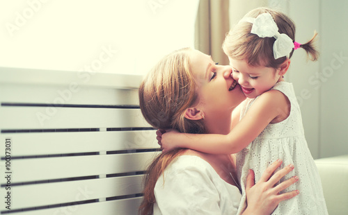 Happy loving family. mother and child playing, kissing and hugg