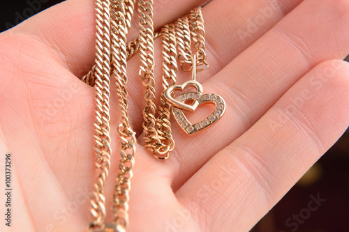 gold pendant in the shape of a heart on a Valentine's Day gift