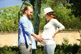 Happy moments in waiting baby's birth - man and woman walking in the park