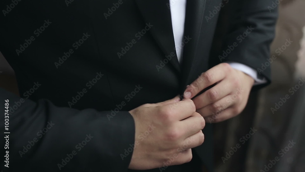 Correct button on jacket, hands close-up, dressing Correct button on jacket, hands close-up, dressing