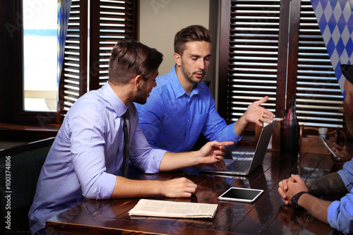 Young men talking in cafe