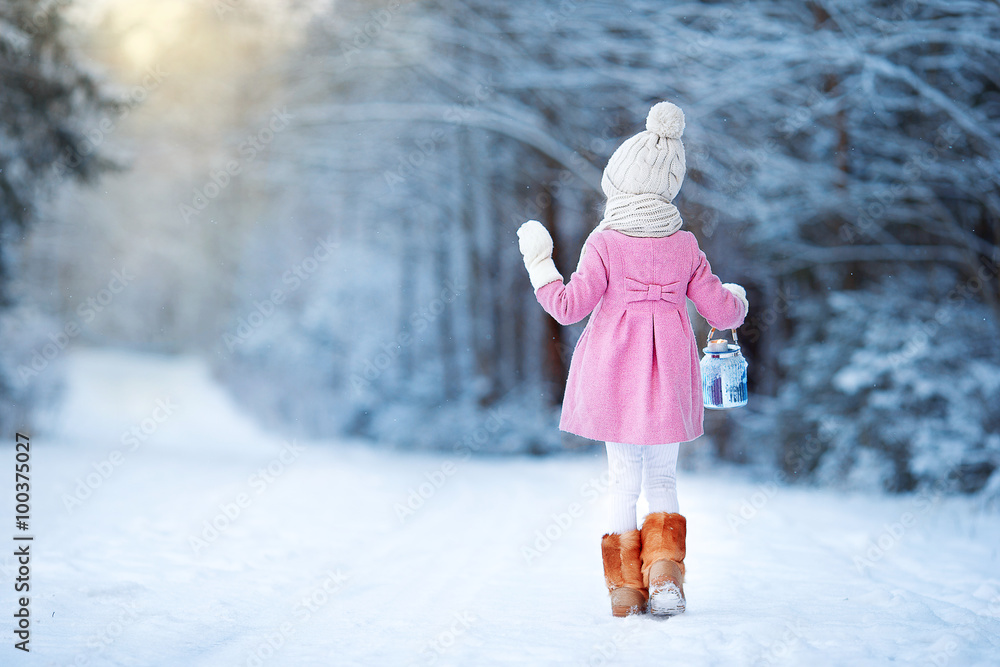 Adorable girl with lamp and candle in winter on Xmas eve outdoors - obrazy, fototapety, plakaty 