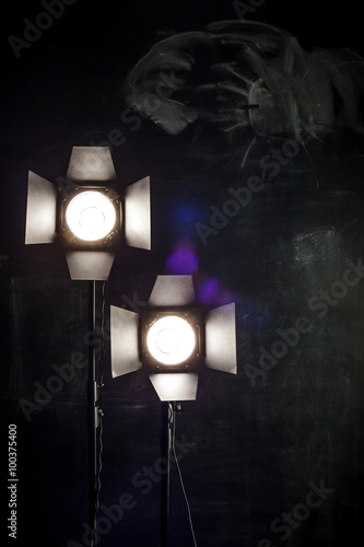 Lighting equipment on a black background old shabby wall © Viktor Koldunov