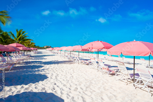 Empty exotic beach and lounges on exotic tropical island at Caribbean sea