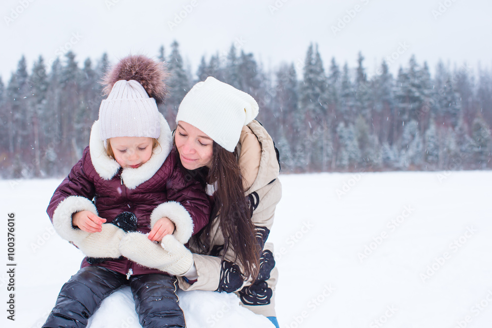 Happy family enjoy winter snowy day