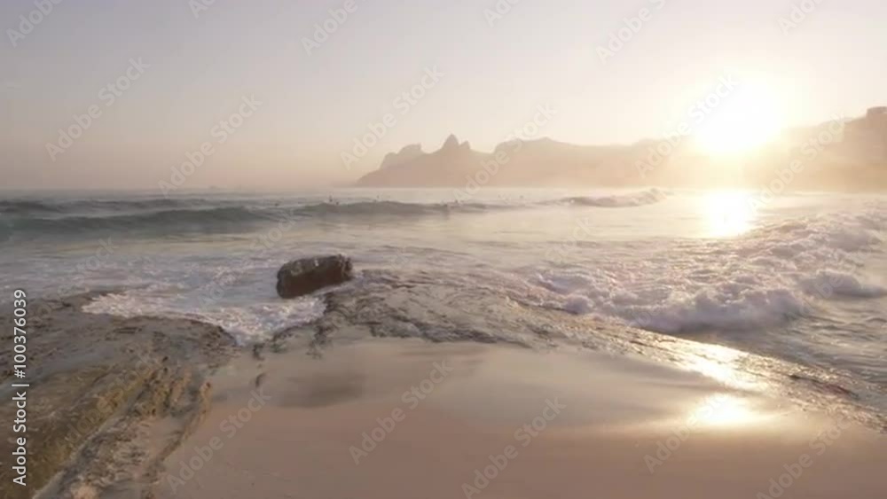Waves hitting shoreline and people playing in ocean Waves hitting shoreline and people playing in ocean