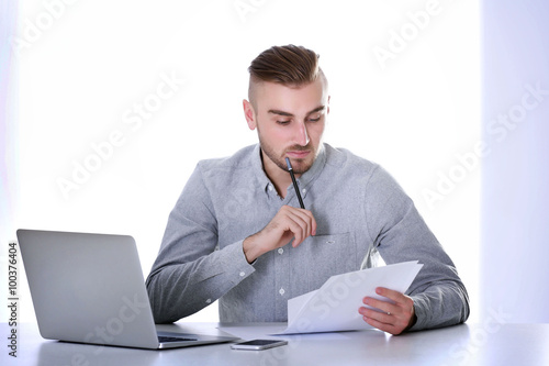Businessman working with la...
