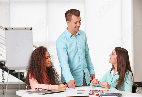 Young business people discussing a new project at the meeting in a conference room