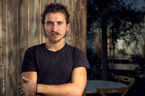 Hip trendy male restaurant owner standing portrait arms crossed hipster mustache facial hair headshot