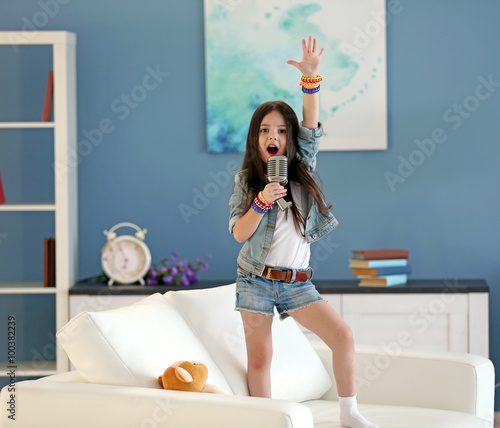 Artistic little girl singin...