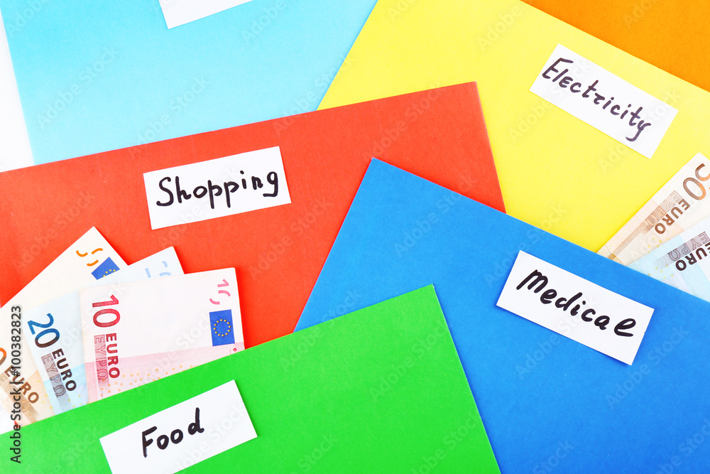 Colourful envelopes with money for needs, close up Colourful envelopes with money for needs, close up