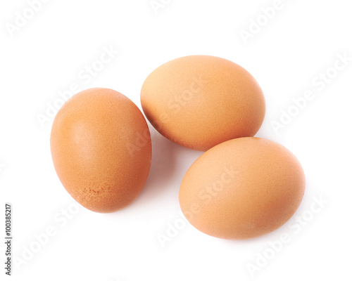 Three brown eggs composition isolated