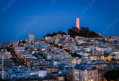 Coit tower and houses on the hill san francisco at night photo