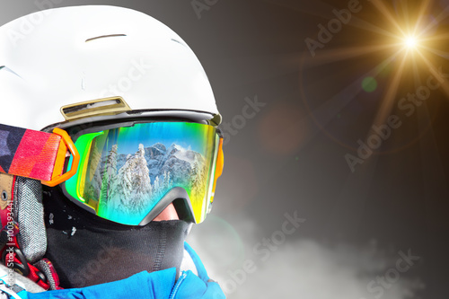 Portrait of skier on dark background.