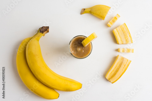Banana smoothie on the wooden background