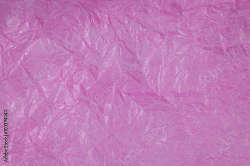 Pink crumpled paper surface background.
