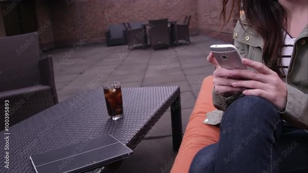 Panning view from table to womans face as she answers smartphone. Panning view from table to womans face as she answers smartphone.