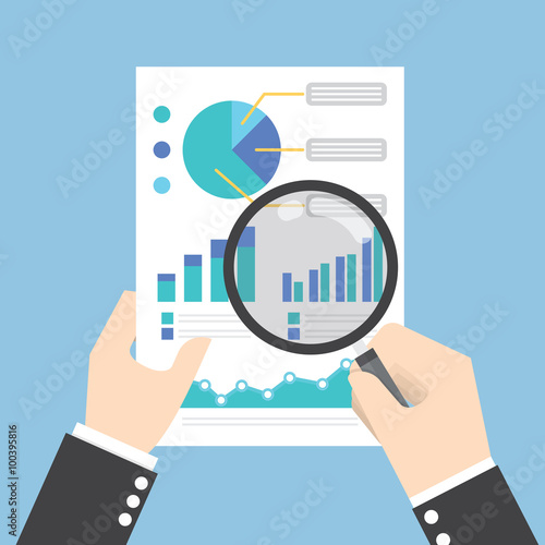 Businessman hands holding a magnifying glass and analysing the d