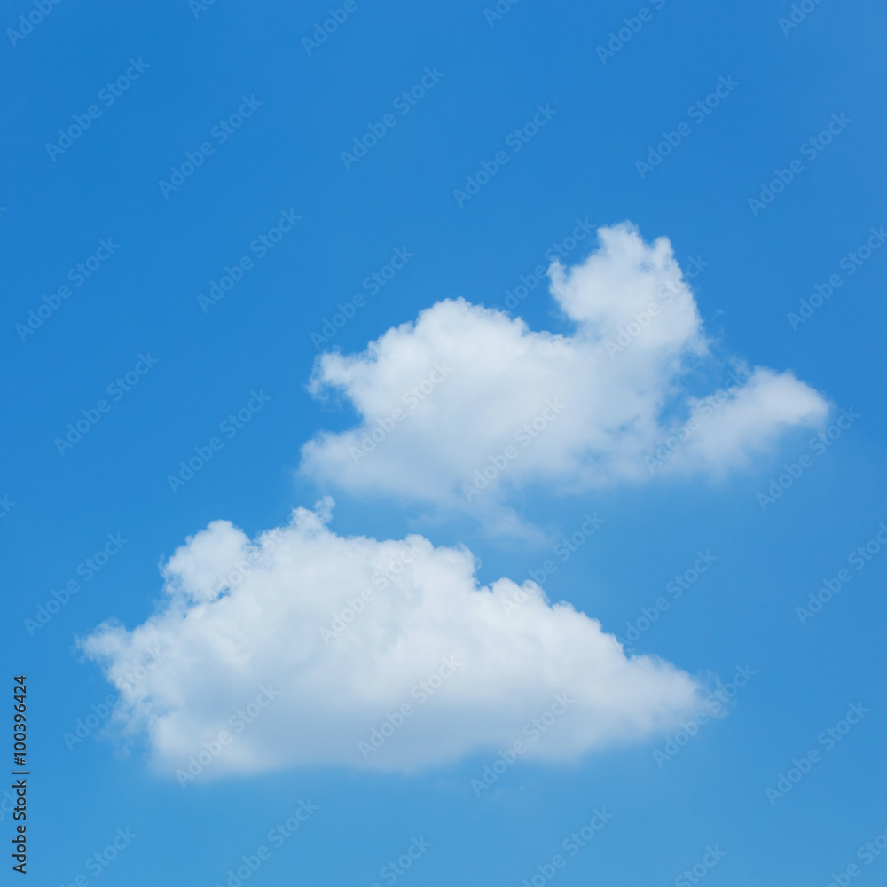 fluffy white cloud floating on clear blue sky background