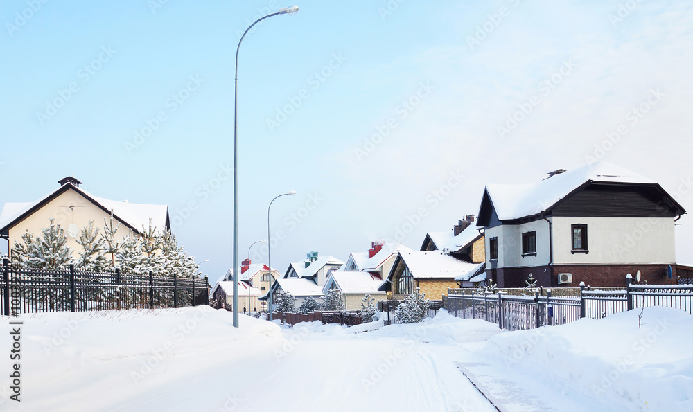 Snowy street with cottages in the winter village