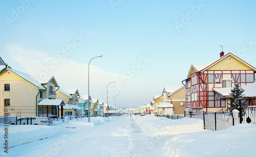 Street with cottages in the winter village photo