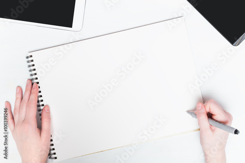 Woman hand with pen on a white background. Mockup