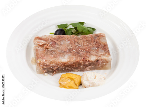 portion of meat aspic with seasonings on plate