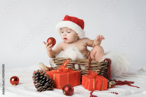 baby in a Christmas hat Santa in the basket