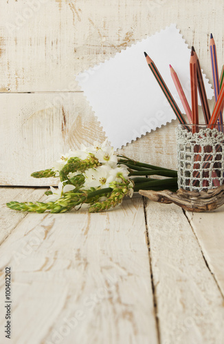 Pencils in the glass and flowers, selective focus photo